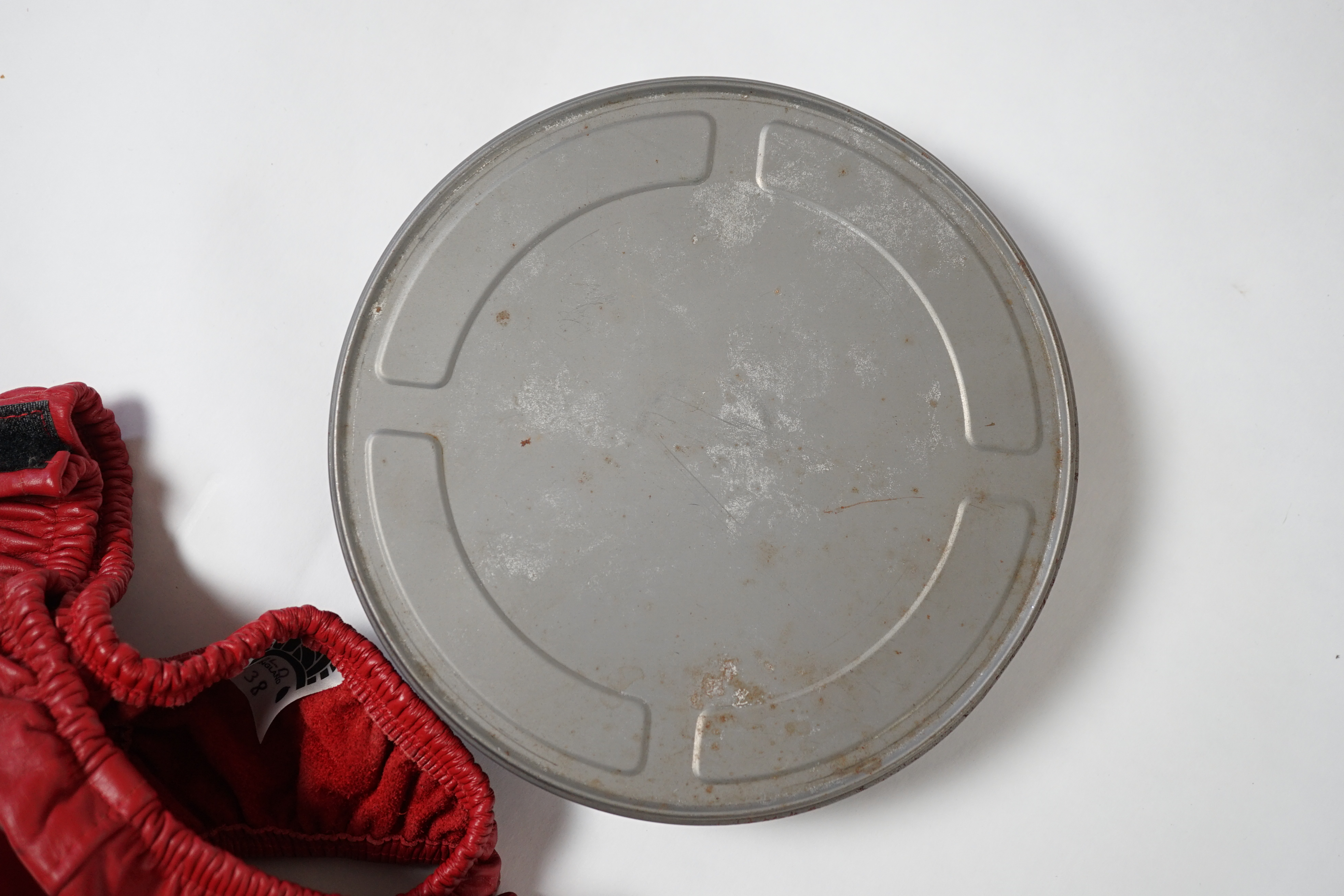 A red leather thong, as worn by Tom Wilkinson in the film The Full Monty and signed by him, together with a signed note confirming authenticity.